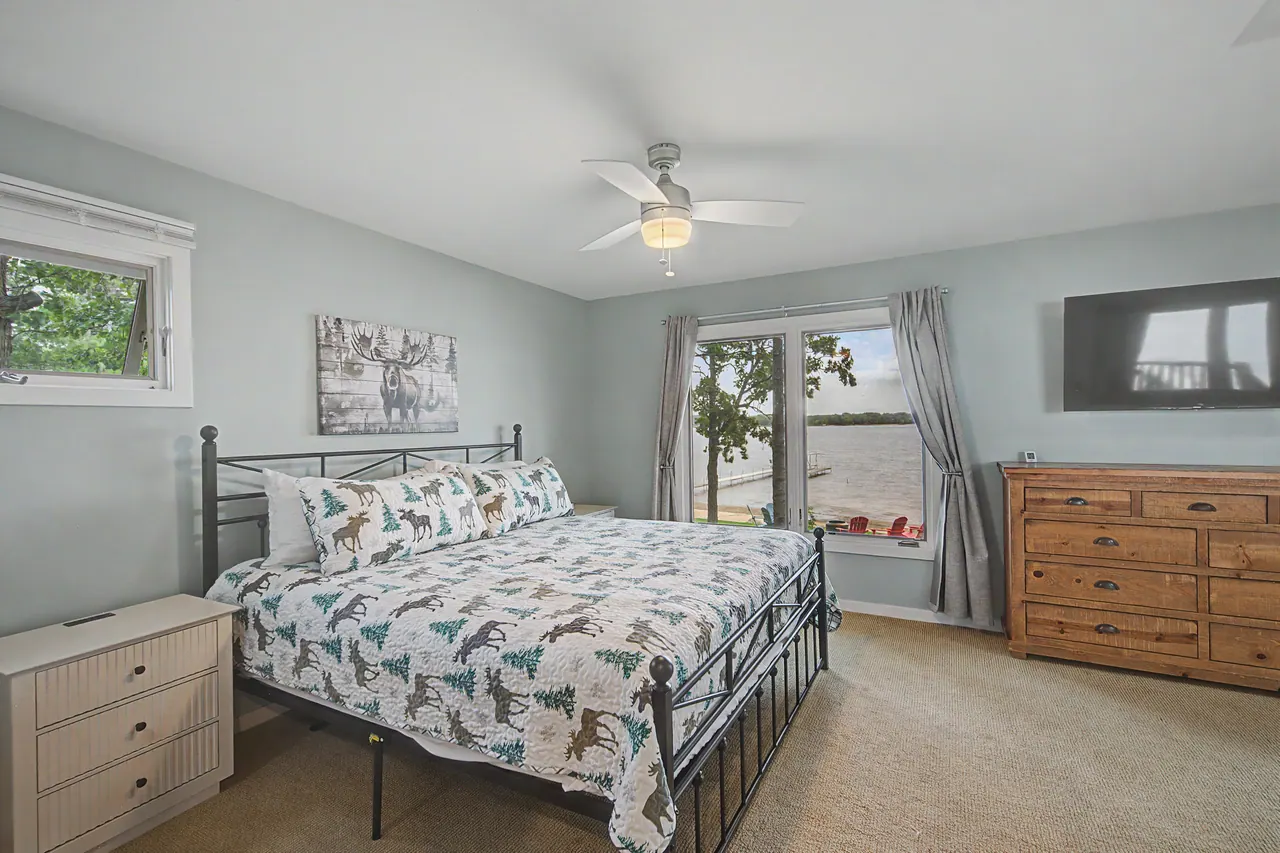 Bedroom with an iron-frame bed and a wood dresser