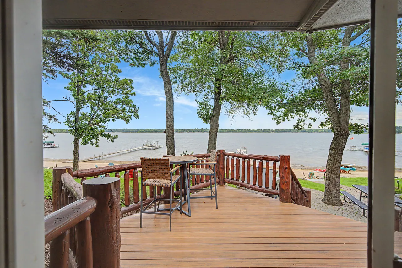 Covered deck with bar-height seating looking over the lake