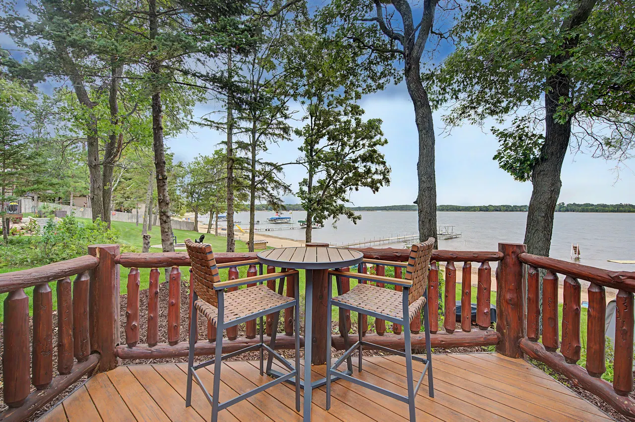 High-top table on the log-railed deck above the lake