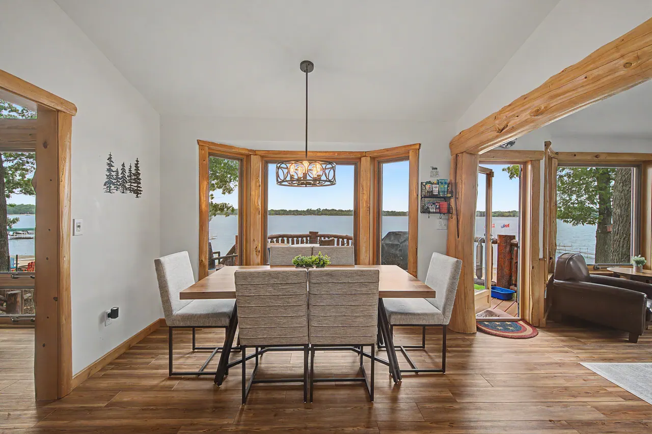 Dining table in a bay of windows looking out at the lake