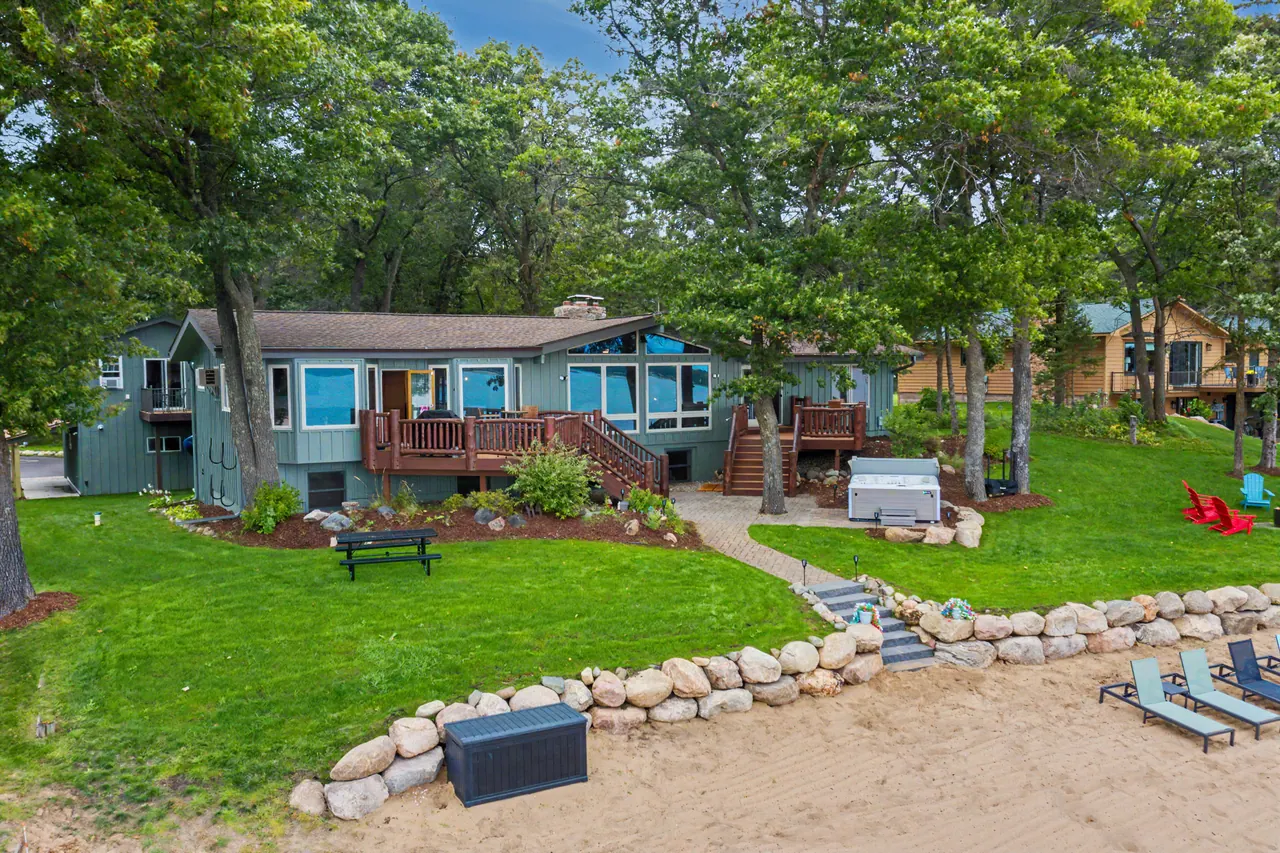 Lakeside lawn and deck with steps down to the beach